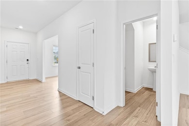 Entryway featuring light wood-style floors and recessed lighting