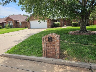 Ranch-style house featuring a front lawn and a garage
