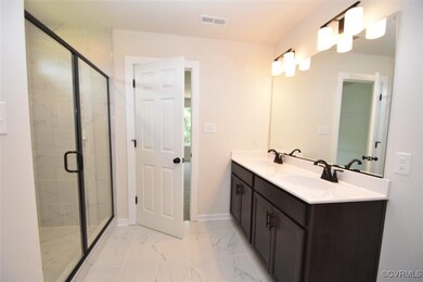 Bathroom featuring vanity and walk in shower