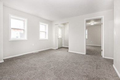 Living room with carpet flooring and baseboards