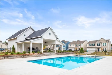 Pool with fence, ceiling fan, a patio area, and a 