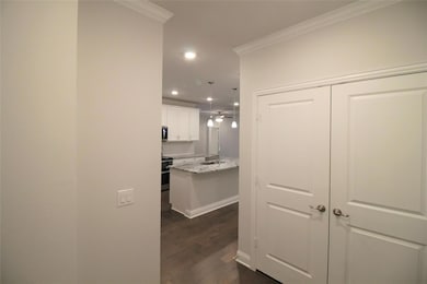Corridor featuring dark wood finished floors, crow