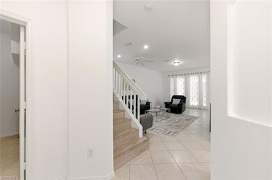 Staircase with tile patterned floors, recessed lighting, and ceiling fan