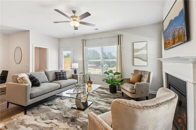 Living area featuring wood finished floors, a glas