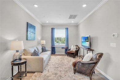 Living area featuring visible vents, baseboards, a