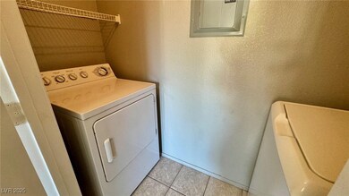 Washroom featuring washer / dryer, electric panel,