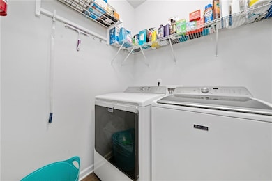 Clothes washing area featuring washer and dryer