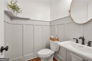 Crisp updates and thoughtful details give this guest half bath a polished, welcoming feel.