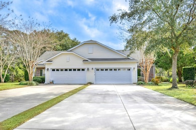 View of front of home with a garage and a front ya