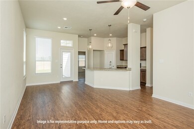 Kitchen featuring open floor plan, dark wood-style floors, light stone counters, pendant lighting, and recessed lighting