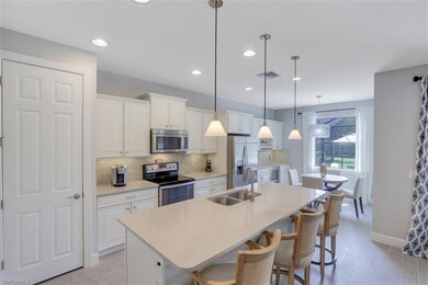 Large kitchen island, white cabinets, and stainles