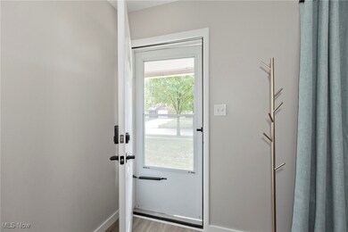 Entryway featuring baseboards and wood finished floors