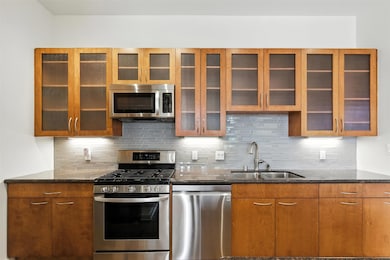 Modern kitchen, updated appliances, glass cabinetry. Tons of counterspace.