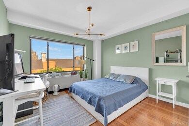 Bedroom featuring wood finished floors and a chandelier