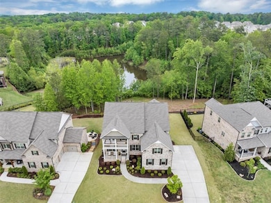 Aerial view with a water view and a forest view