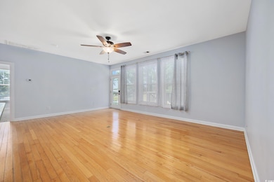 Unfurnished room with ceiling fan, light wood-type