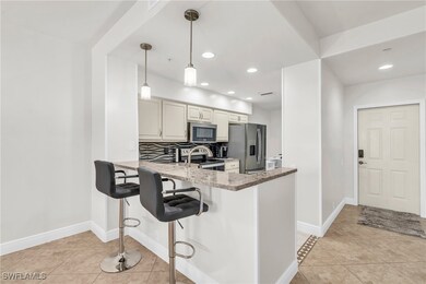 Kitchen with light stone counters, light tile patt