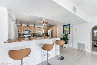 Kitchen featuring stainless steel appliances, arch