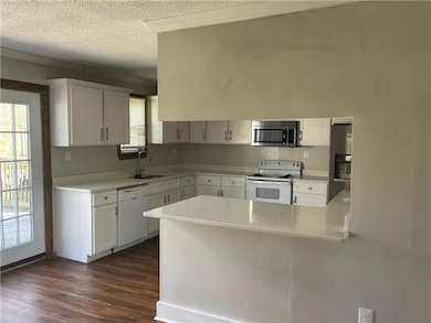 Kitchen featuring stainless steel appliances, a si
