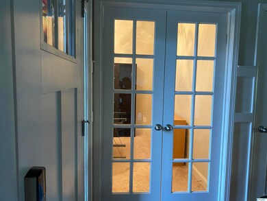 Features French doors and has closet with shelving