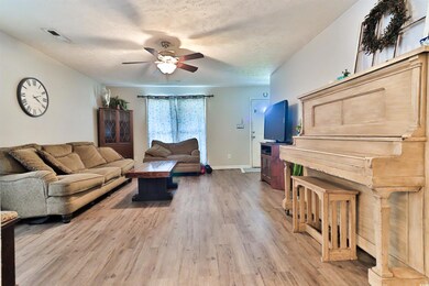 Living room with light hardwood / wood-style floor