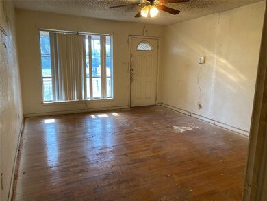 Foyer entrance with wood-type flooring, ceiling fa