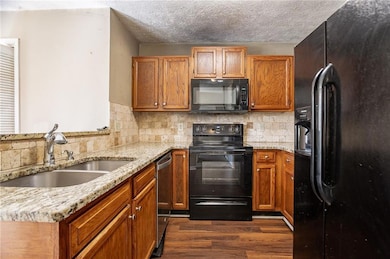 Kitchen with tasteful backsplash, a textured ceili