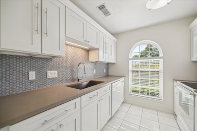 Upgraded kitchen with quartz countertops, mosaic t