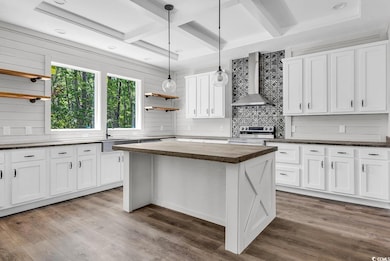 Kitchen with open shelves, butcher block countertops, white cabinets, coffered ceiling, and beamed ceiling