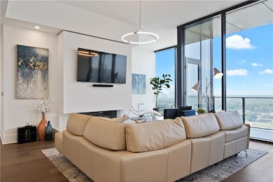 Living room with dark wood-style floors and recessed lighting