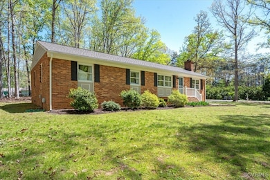 Ranch-style home with a chimney, brick siding, and