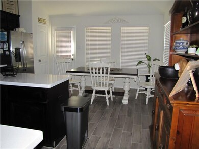 KITCHEN LOOKING TOWARD DINING AREA AND DOOR TO BAC