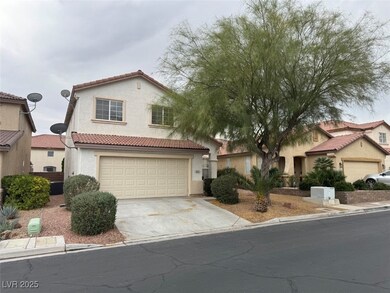 Mediterranean / spanish home featuring concrete driveway, a tile roof, and stucco siding
