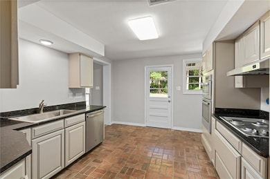 Kitchen with stainless steel appliances, baseboard