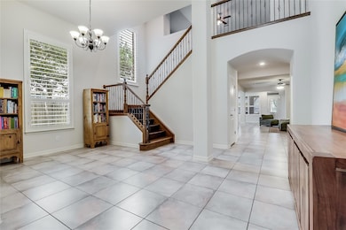 Entryway with arched walkways, a chandelier, plen