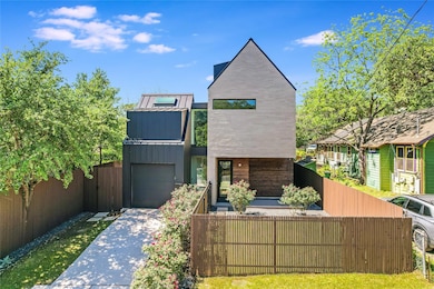 Contemporary home with concrete driveway, a garag