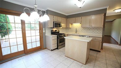 Another view of the kitchen & deck. Laundry is conveniently located just off the kitchen.