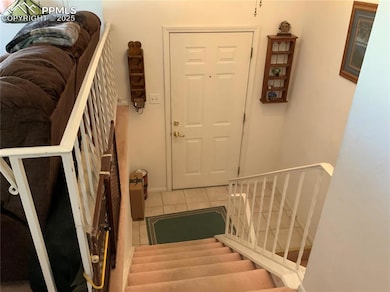 Stairs featuring tile patterned floors