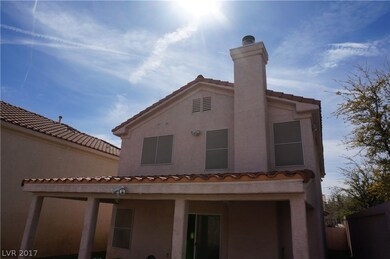 Covered tile roof patio with stuccoed pillars, and