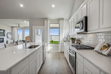 Kitchen in the Wimbledon home plan by Trophy Signature Homes – REPRESENTATIVE PHOTO