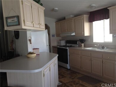 KITCHEN WITH A BAR THAT OPENS TO LIVING ROOM