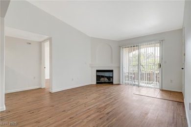 Unfurnished living room with light wood-style floo