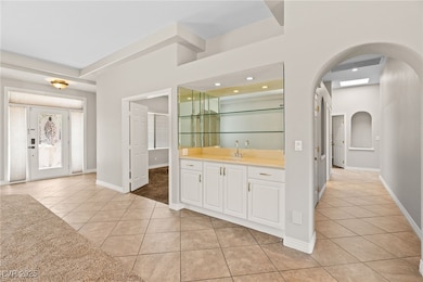 Indoor bar featuring arched walkways, light tile p