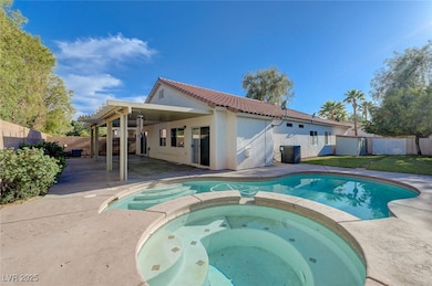 View of swimming pool with hot tub, a covered pati