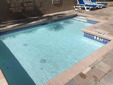 Community pool featuring a patio