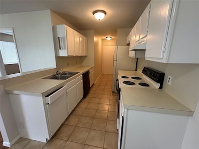 Kitchen featuring white appliances, under cabinet
