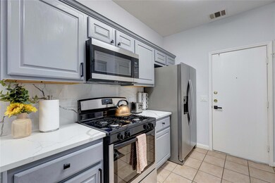 Kitchen featuring stainless steel appliances, gra