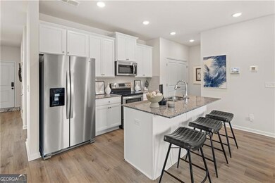 Living area featuring healthy amount of natural light, light wood-style floors, and a ceiling fan