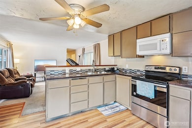 hardwood flooring in Kitchen with backsplash tile