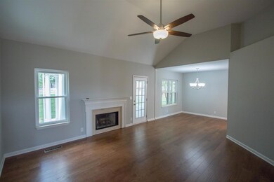 Living room with vaulted ceilings and open to the dining room. Has entry to backyard and screened porch. New hardwood floors.